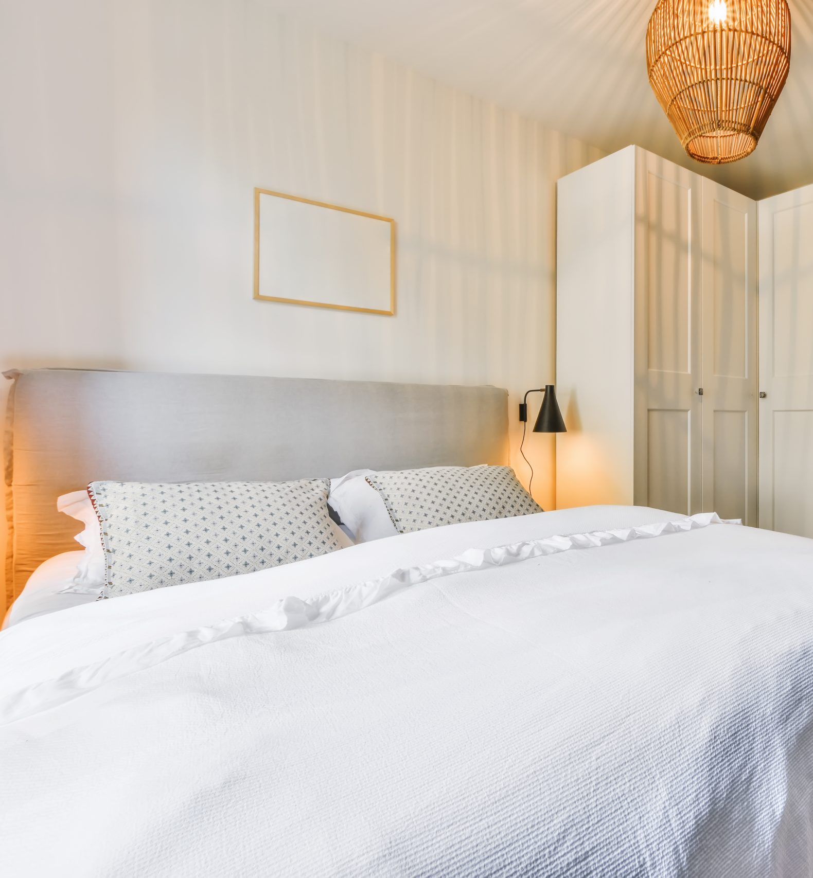 Designer bedroom with a soft bed and an unusual chandelier above it