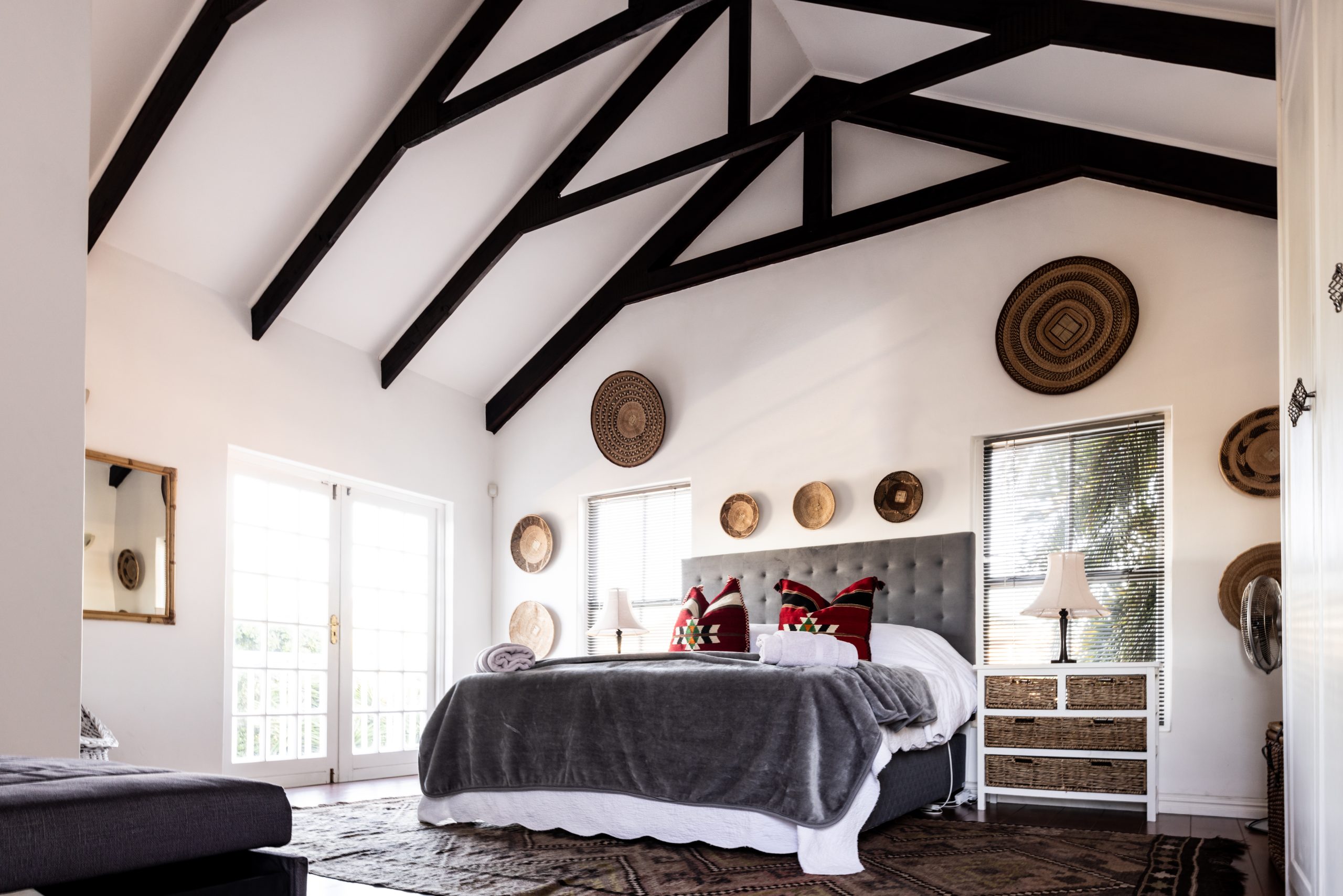 Empty neat bed with blankets and pillows under mansard roof in modern bedroom, copy space. Unaltered, carpet, furniture, home and interior decoration concept.